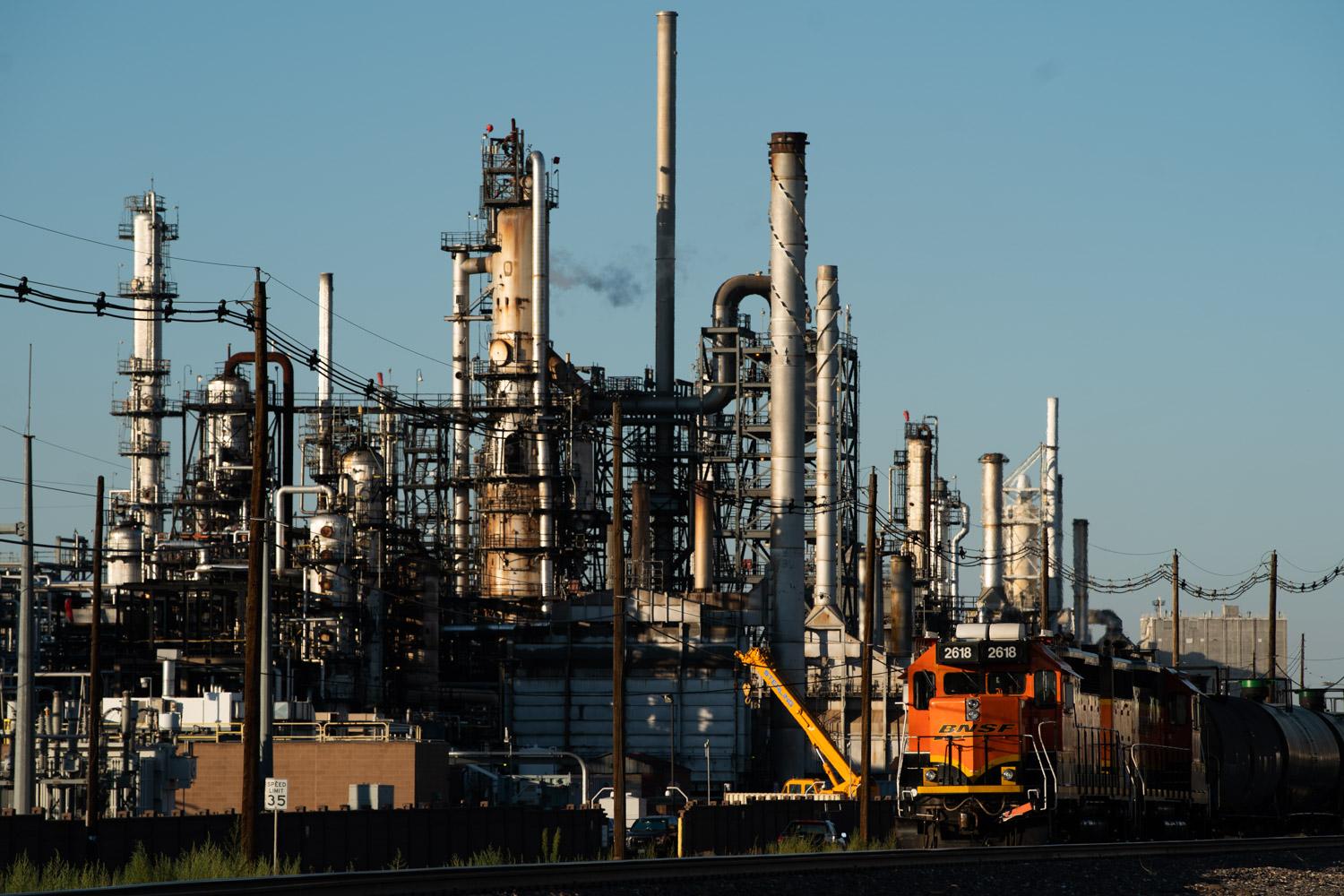 The Suncor oil refinery in Commerce City with several large pipes and other heavy machinery pictured.