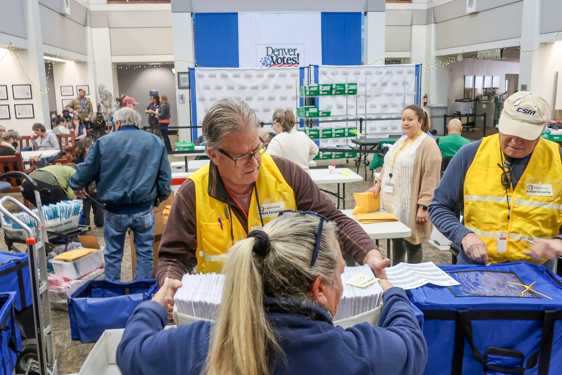 Elections workers from Arapahoe and Denver elections offices inside the Denver County Elections Division Office