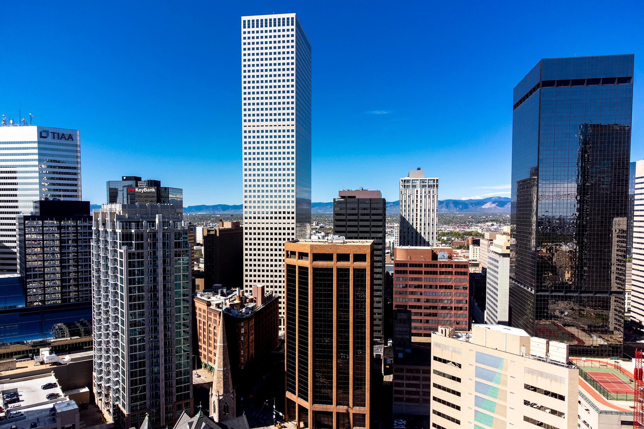 A bunch of downtown Denver skyscrapers on a sunny, blue-sky day.