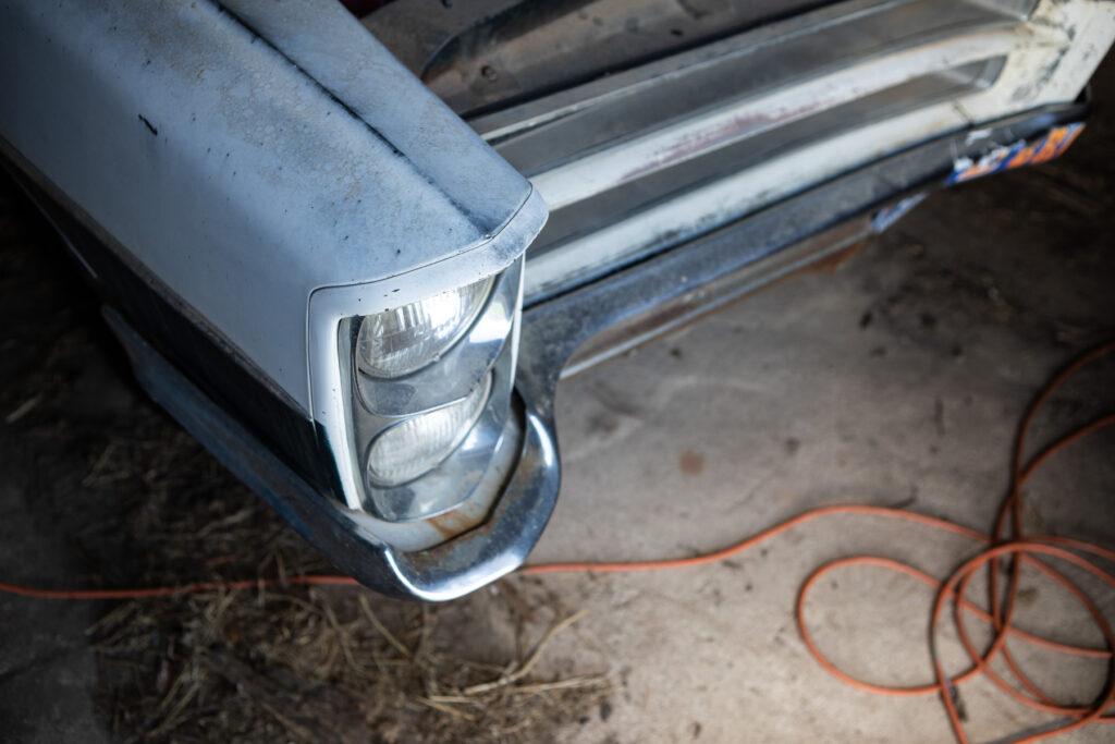 The front headlight of a 1966 Pontiac Catalina that was turned into a housecar