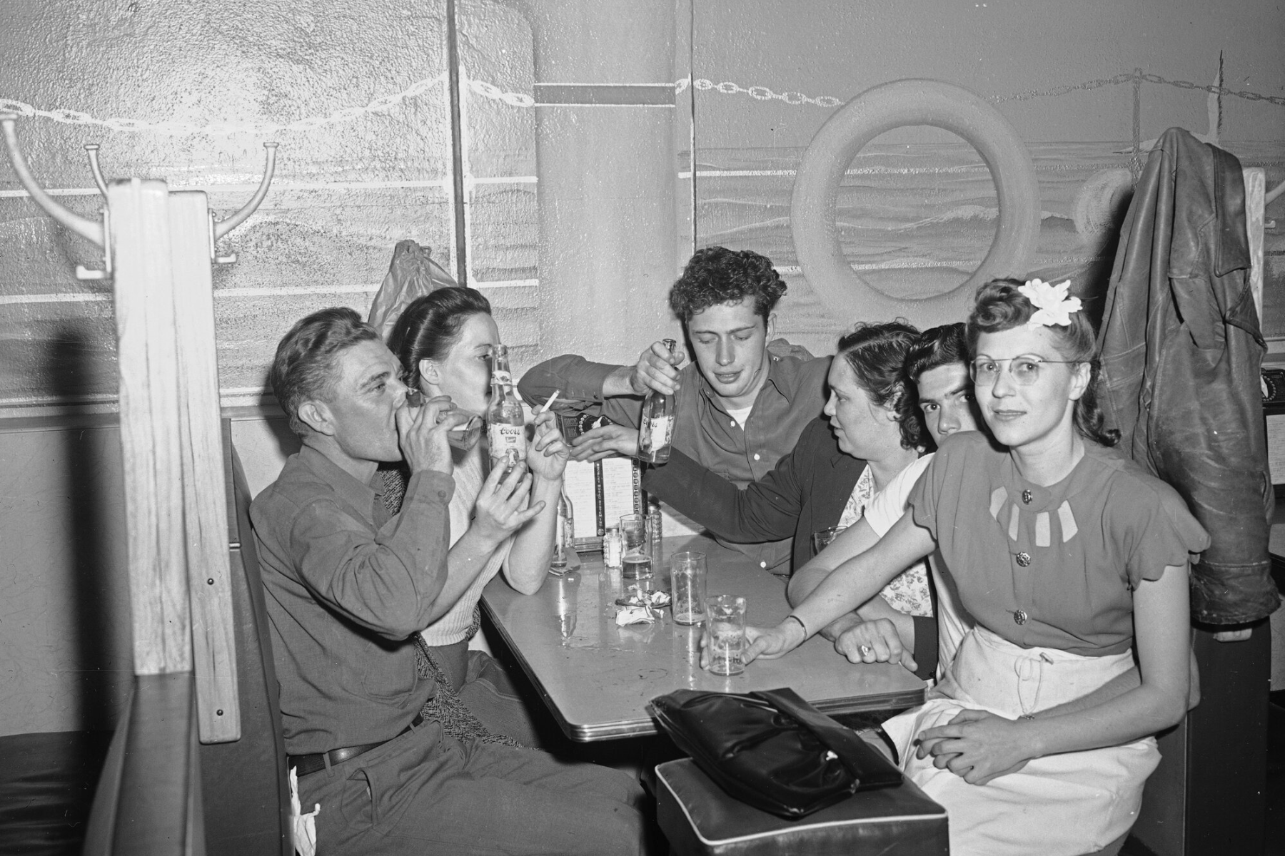 A group of men and women sit at a table at the Marine Grill