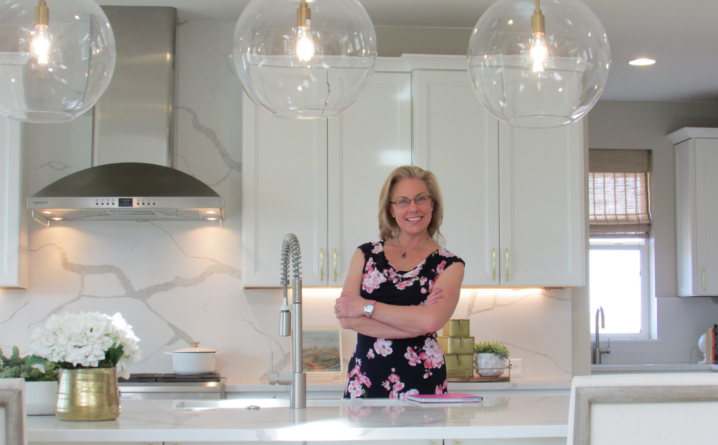 Realtor Rhonda Basey is seen standing in a kitchen of a house. She works with the Douglas County Sheriff's Office to education older people about real estate scams.